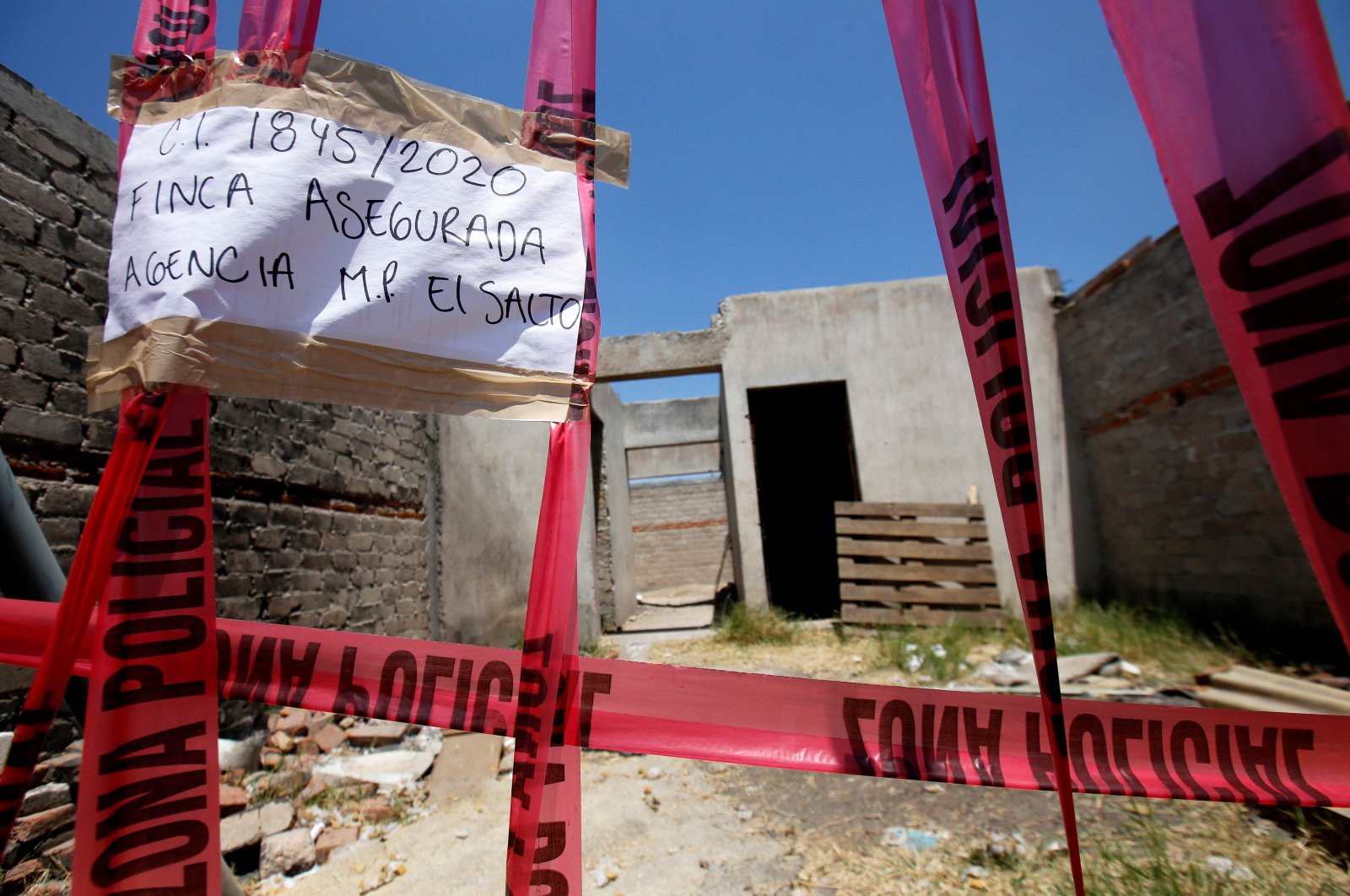 Picture of a taped-off unfinished construction at the farm where the remains of at least 25 people were found buried in a clandestine mass grave in the municipality of El Salto, outside the western Mexican city of Guadalajara, in Jalisco State, May 10, 2020. (AFP Photo)