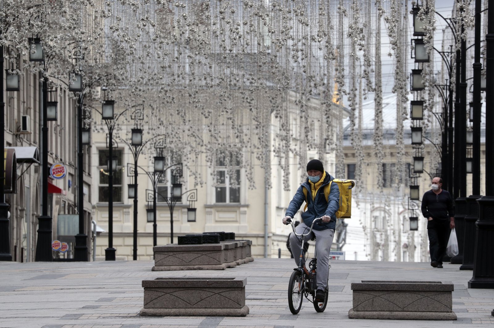A food courier bikes to his client along a deserted street, Moscow, Russia, May 8, 2020. (EPA Photo)