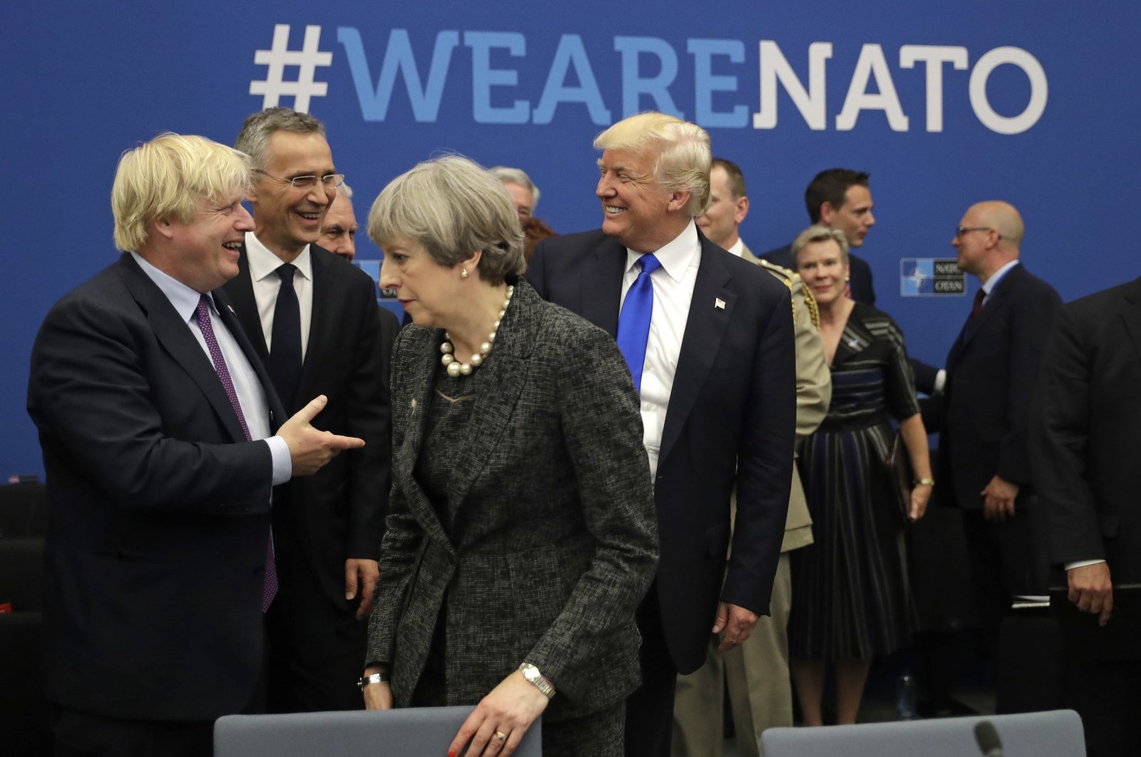 U.S. President Donald Trump jokes with Boris Johnson during a working dinner meeting at the NATO headquarters in May 25, 2017. (AP Photo) 