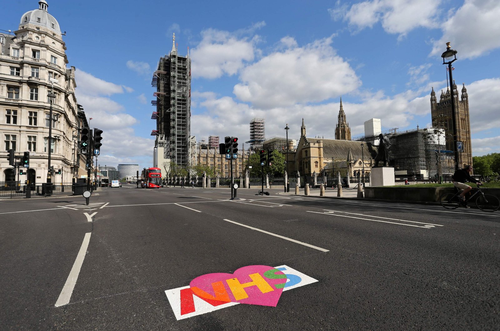 A logo of Britain's NHS (National Health Service) is pictured on an empty road near the Houses of Parliament in central London on May 11, 2020. (AFP Photo)
