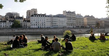 People gather along banks of the Seine river in Paris on the first day of France's easing of lockdown measures in place for 55 days to curb the spread of the coronavirus, May 11, 2020. (AFP Photo)