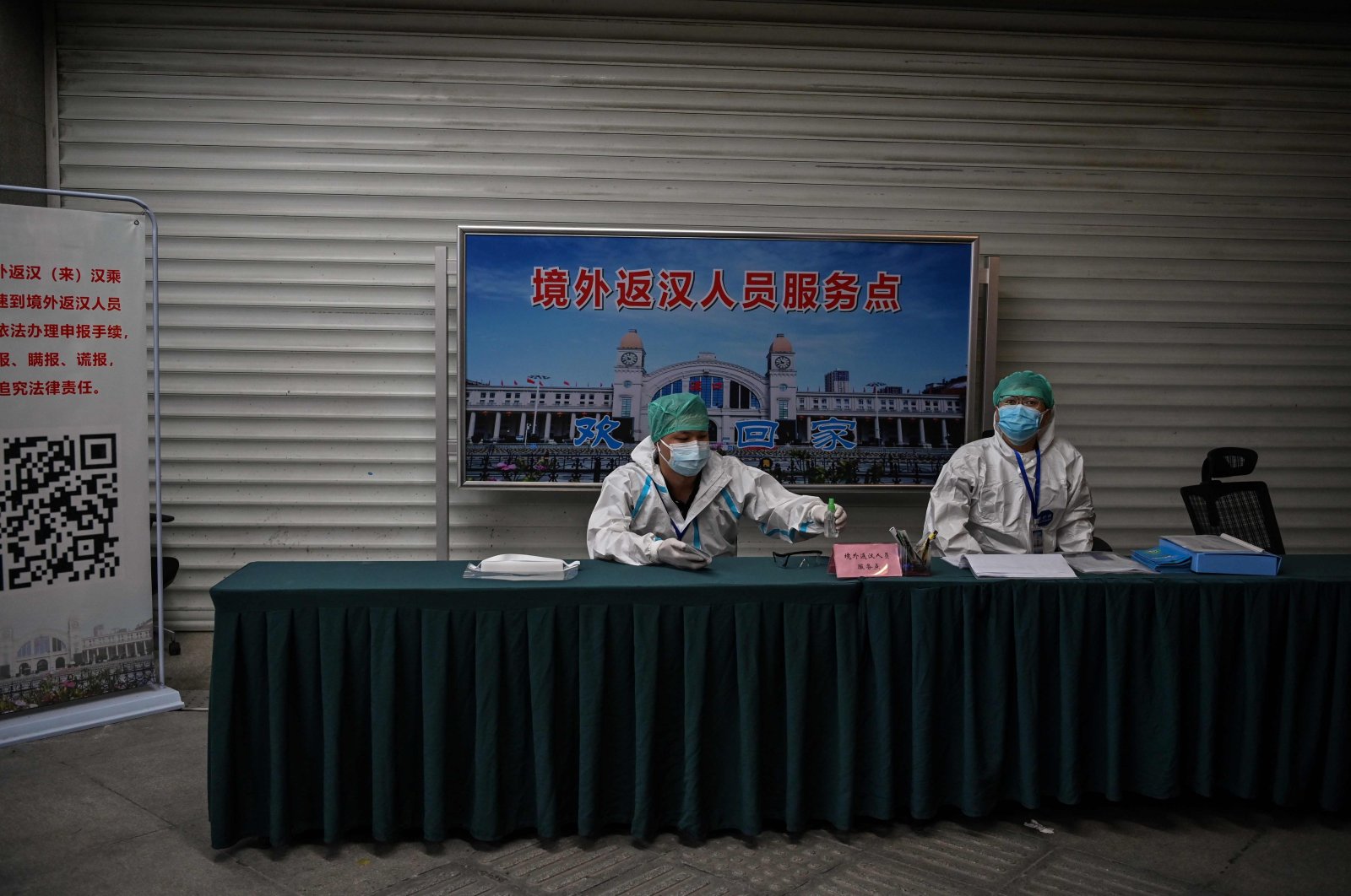 Employees wearing protective gear work at Hankou railway station, Wuhan, China, May 12, 2020. (AFP Photo)