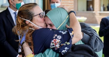 Silvia Romano, an Italian aid worker who was kidnapped by gunmen in Kenya 18 months ago, is kissed by her mother, Francesca Fumagalli, at Ciampino military airport in Rome, Italy, May 10, 2020. (Reuters Photo)