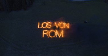 Writing with fire reading in German "Away from Rome", on a field in Val Pusteria, known in German as Pusteral, in the German-speaking province of South Tyrol, Italy, May 2, 2020. (Südtiroler Schützenbund via AP)