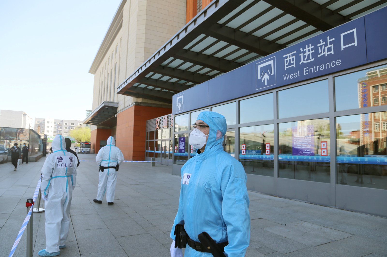 Police officers in protective suits are seen in front a closed entrance to a train station, Jilin, May 13, 2020. (REUTERS Photo)