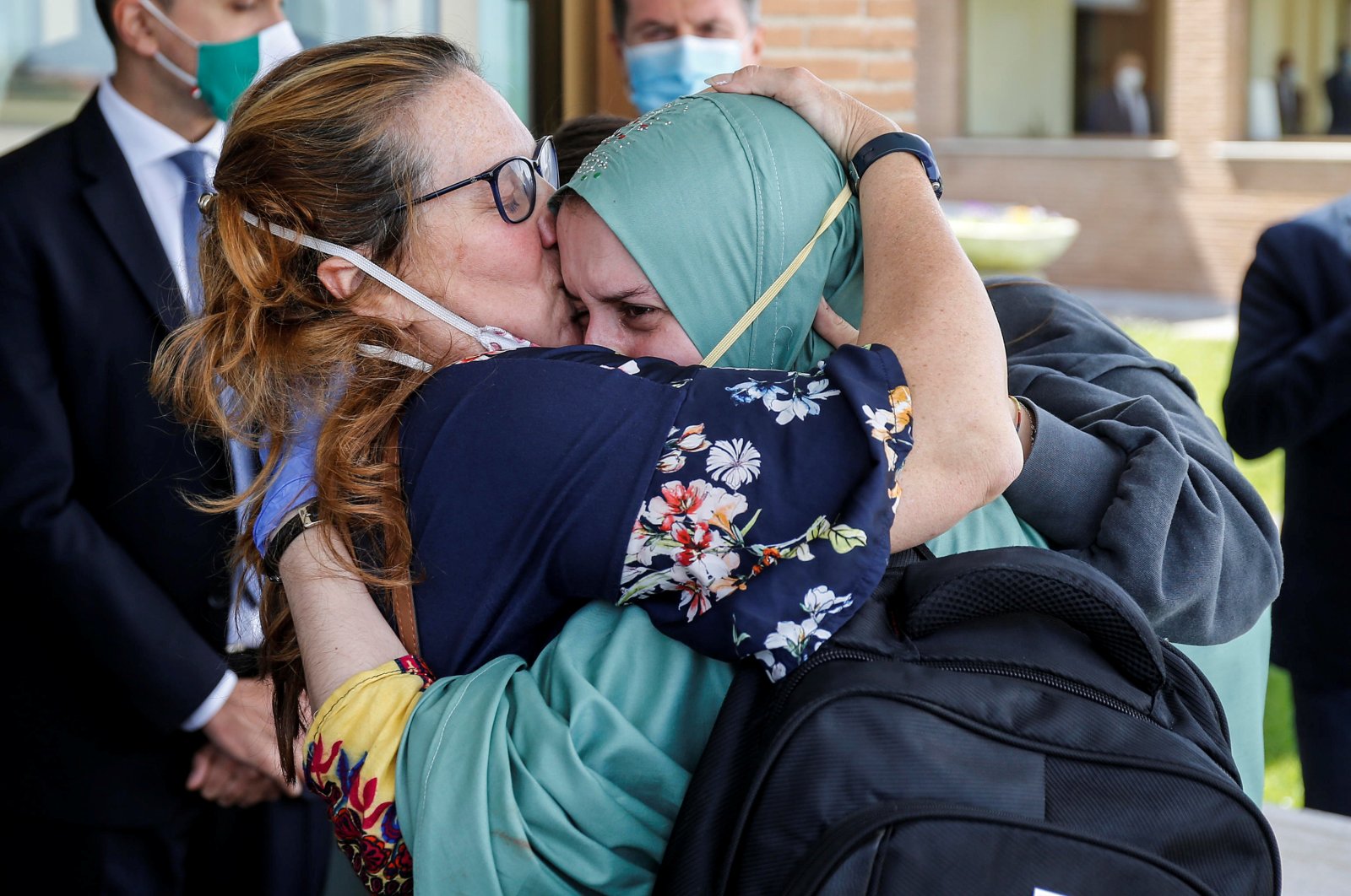 Silvia Romano, an Italian aid worker who was kidnapped by gunmen in Kenya 18 months ago, is kissed by her mother, Francesca Fumagalli, at Ciampino military airport in Rome, Italy, May 10, 2020. (Reuters Photo)