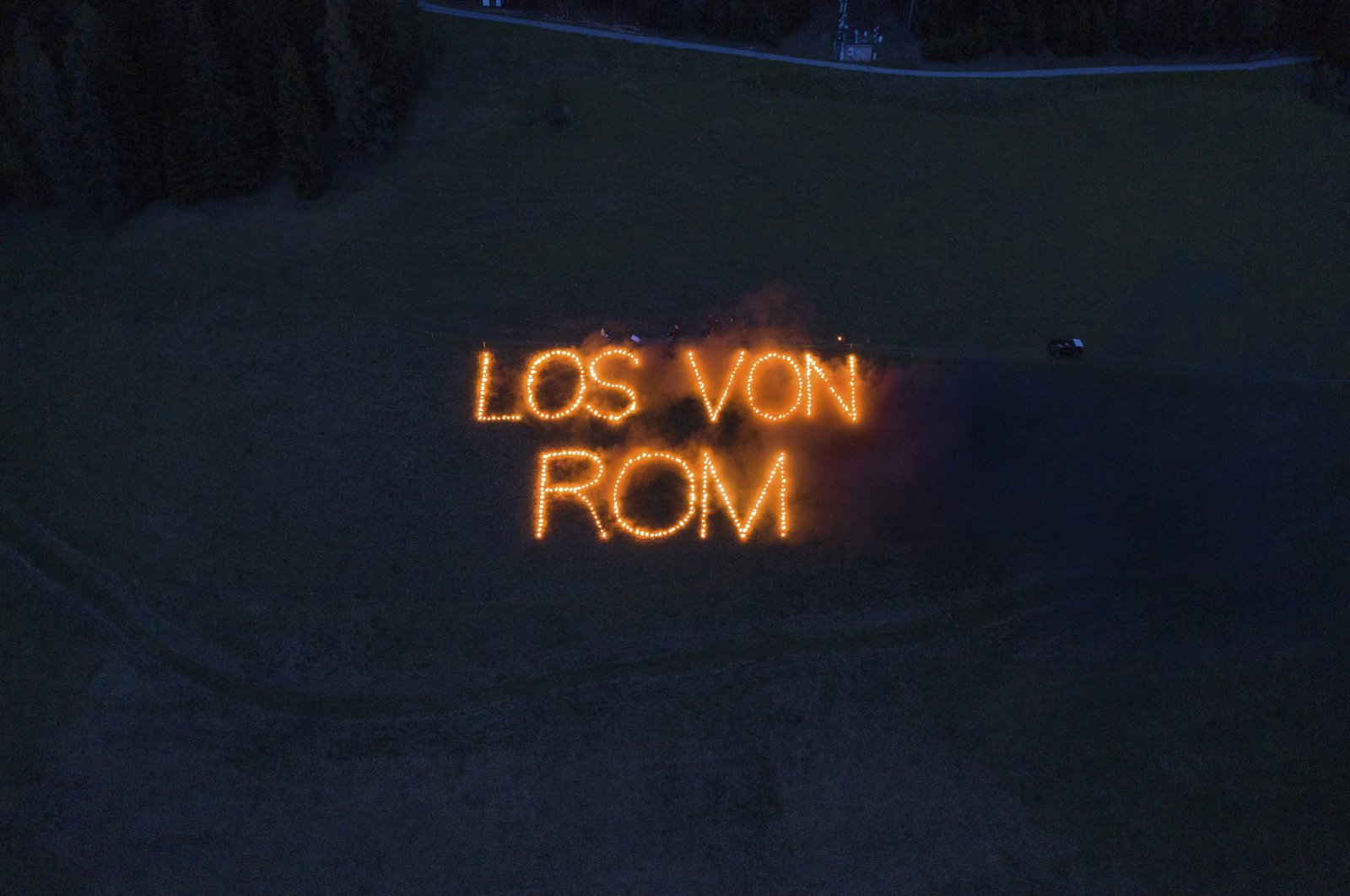 Writing with fire reading in German "Away from Rome", on a field in Val Pusteria, known in German as Pusteral, in the German-speaking province of South Tyrol, Italy, May 2, 2020. (Südtiroler Schützenbund via AP)