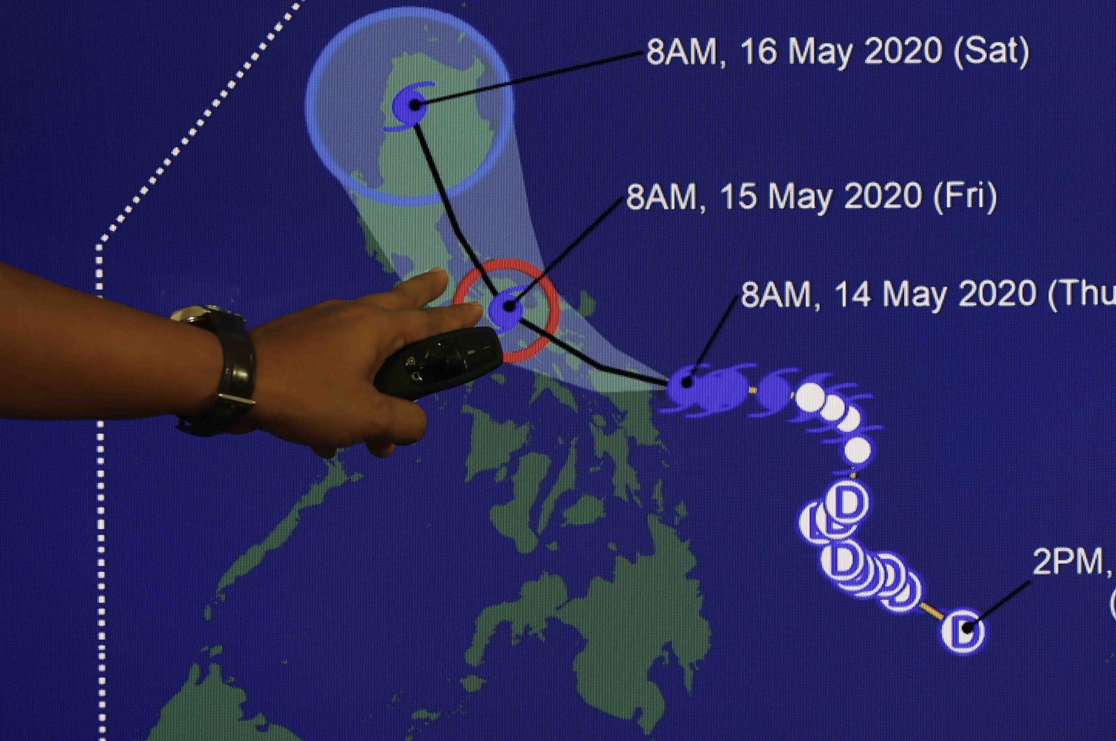 Weather forecaster Christopher Perez points to a projected track of Typhoon Vongfong during a briefing at the Philippine Atmospheric Geophysical and Astronomical Services Administration (PAGASA) headquarters, Quezon City, Metro Manila, Philippines, May 14, 2020. (EPA Photo)