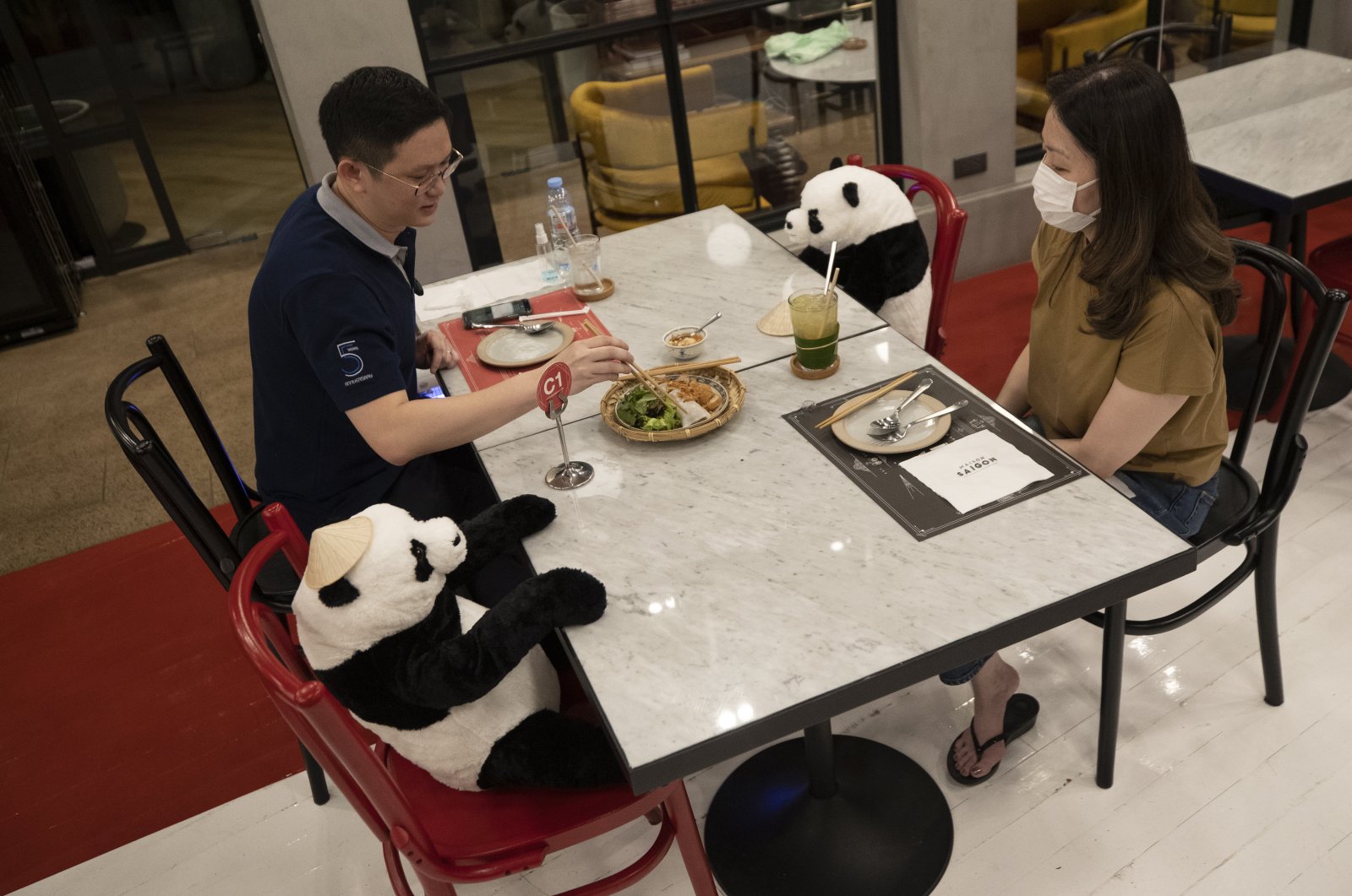 Customers of the Maison Saigon restaurant sit next to stuffed panda dolls the restaurant uses as space keepers for social distancing to help curb the spread of the coronavirus in Bangkok, Thailand, May 5, 2020. (AP Photo)