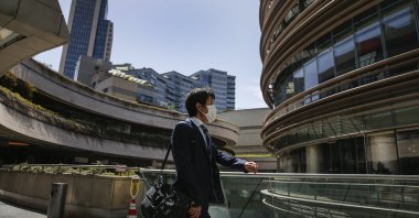 A man, wearing a face mask for protection against the coronavirus, walks in a shopping center in Istanbul, May 11, 2020. (AP Photo)