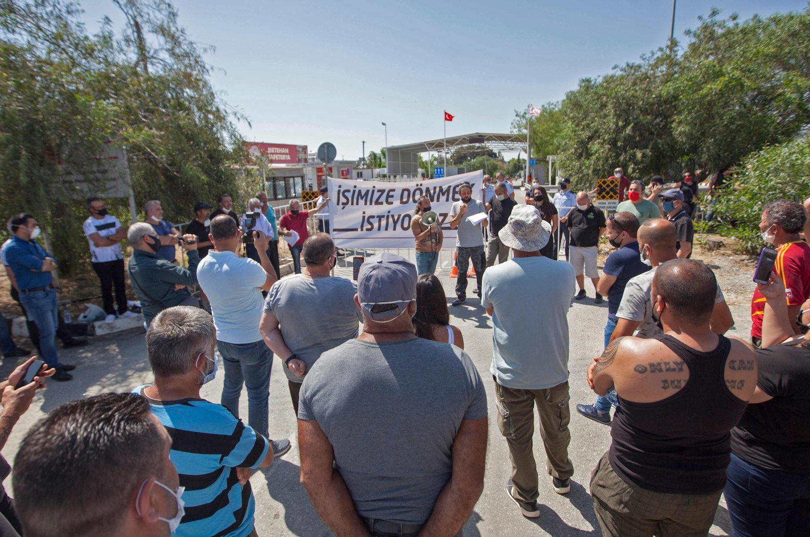Turkish Cypriots living in the north are protesting the Greek Cypriot administration's closure of border gates as part of efforts to stop the spread of the coronavirus at the Ayios Dhometios crossing, May 15, 2020  (AFP Photo)