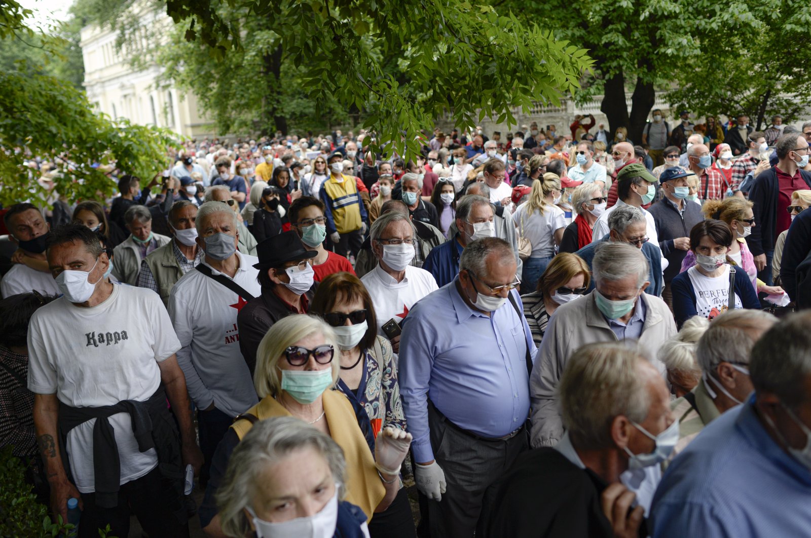 People attend an anti-Nazi protest outside the Sacred Heart Cathedral during a mass commemorating members of the pro-Nazi Croatian WWII Ustasha regime, responsible for sending tens of thousands of Serbs, Gypsies and Jews to their death in concentration camps, who were killed at the end of WWII by Yugoslav communist troops, in Sarajevo, Bosnia, Saturday, May 16, 2020. (AP Photo)
