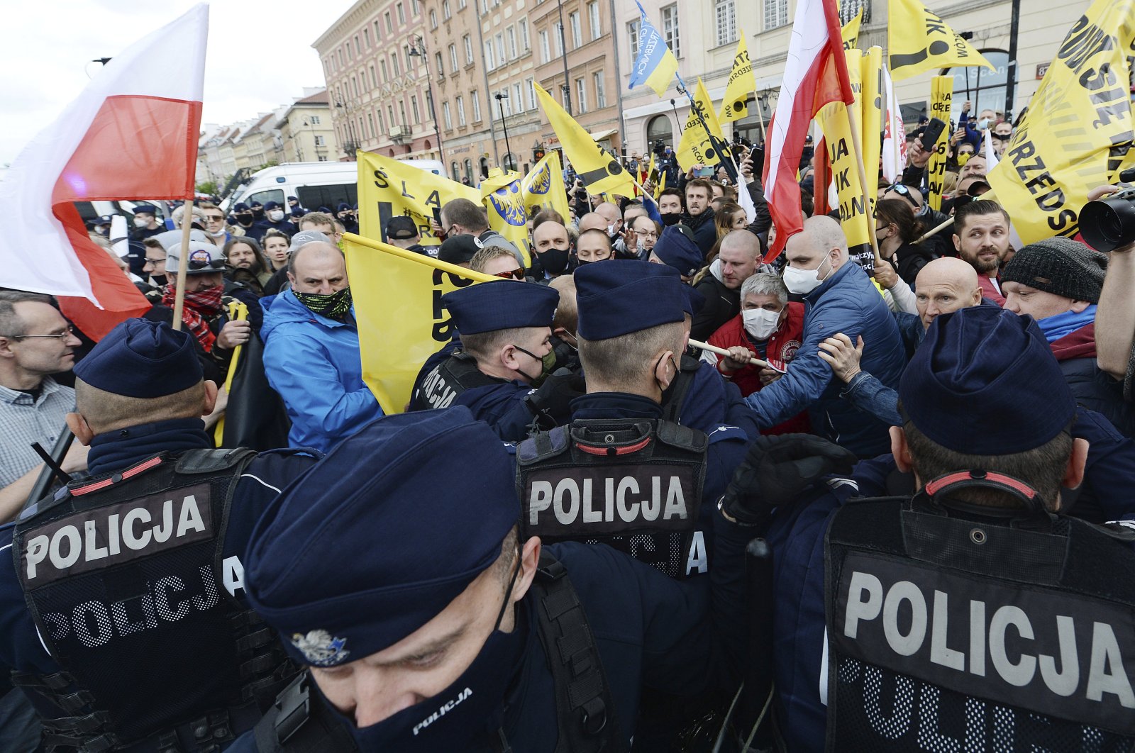 Police clash with protesters demanding an end to economic restrictions during the coronavirus pandemic in Warsaw, Poland, Saturday, May 16, 2020. (AP Photo)