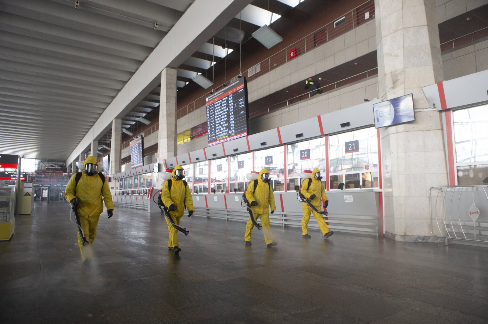 Employees of the Federal State Center for Special Risk Rescue Operations of Russia Emergency Situations disinfect a hall at the Kurskiy railway station in Moscow, Russia, Friday, May 15, 2020. (AP Photo)