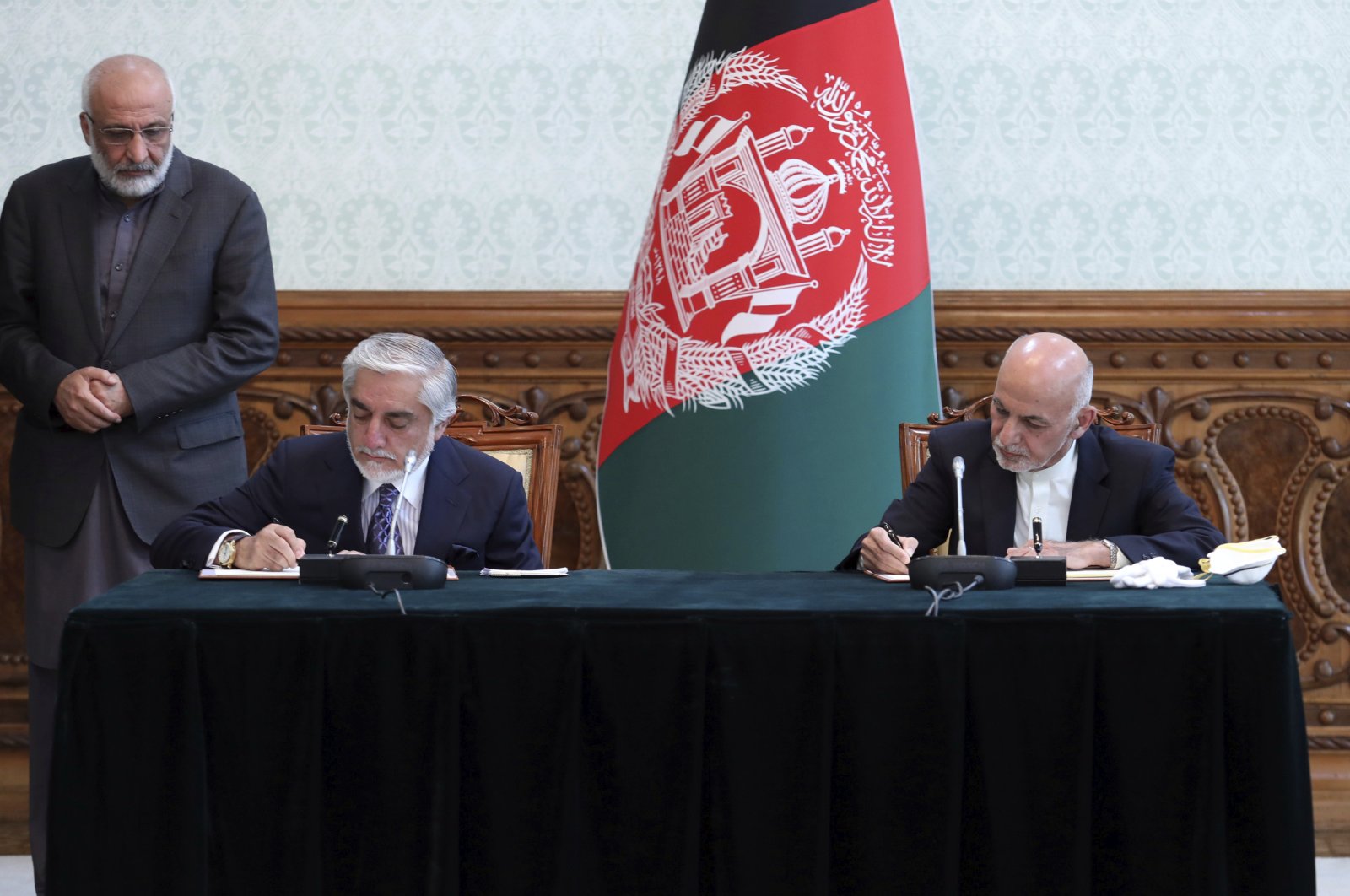 Afghan President Ashraf Ghani, right, and political rival Abdullah Abdullah sign a power-sharing agreement at the presidential palace in Kabul, Afghanistan, Sunday, May 17, 2020. Afghanistan. (AP Photo)