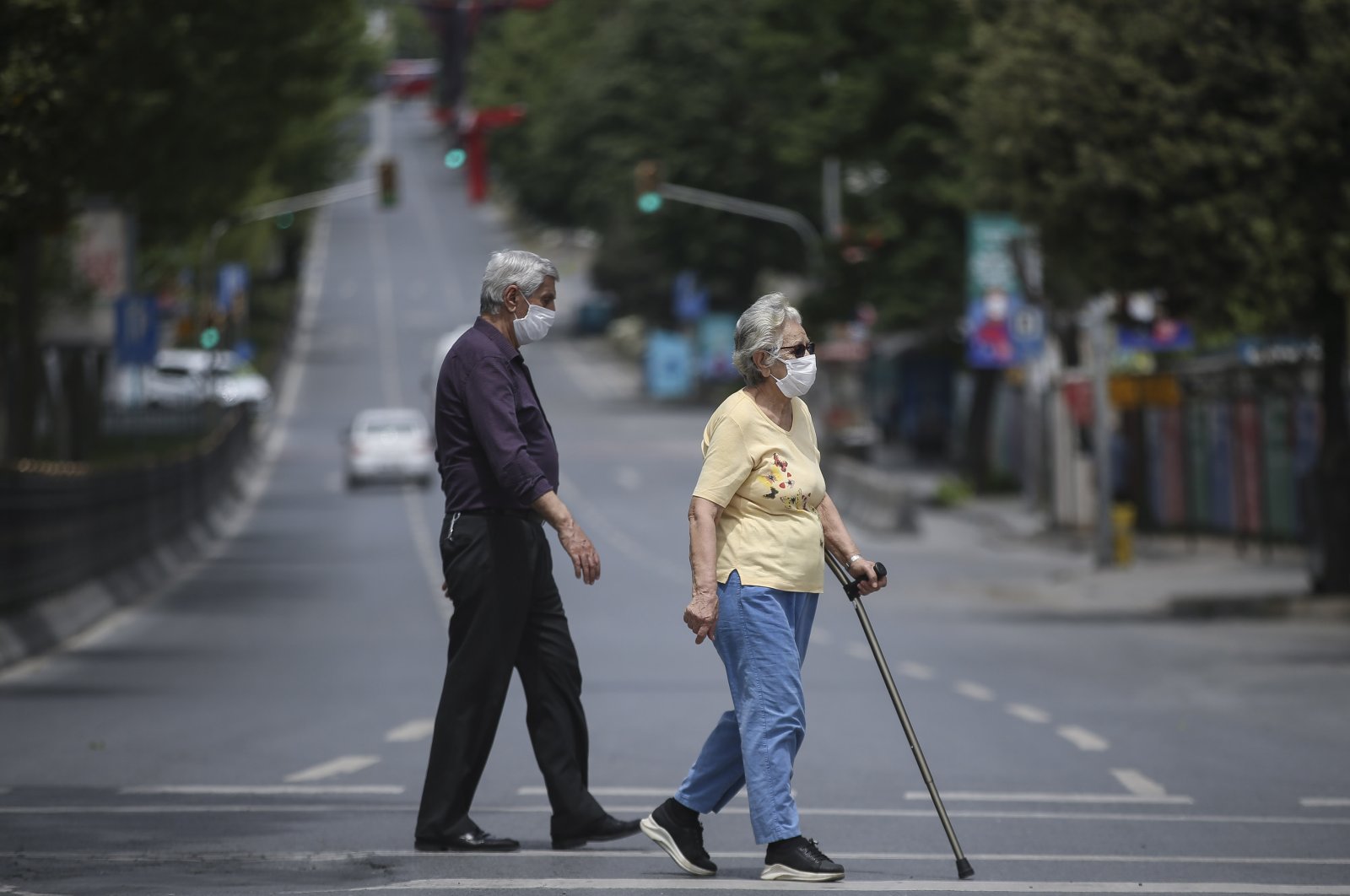 An elderly man and woman walk on the street in Istanbul's Beşiktaş district, Turkey, May 17, 2020. (AA Photo)