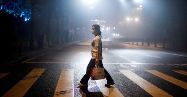 A woman wearing a protective mask walks on a street in Wuhan, the Chinese city where coronavirus originated, Hubei province, China, May 14, 2020. (Reuters Photo)