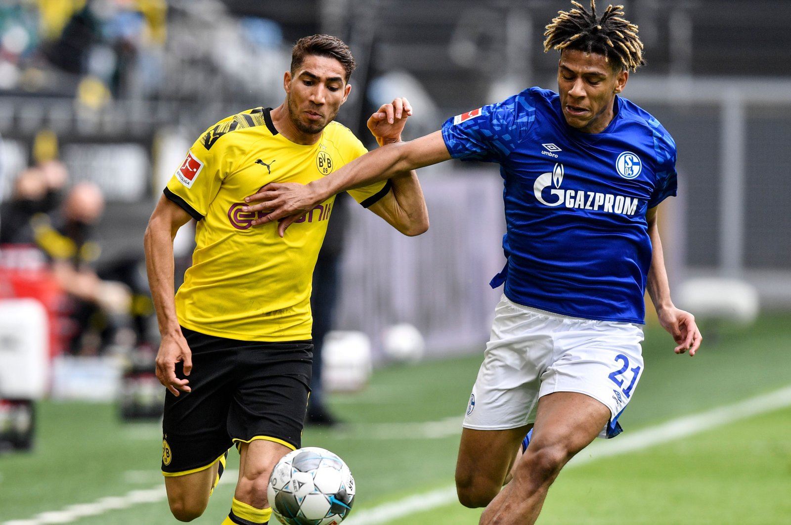 Dortmund's Achraf Hakimi vies for the ball with Schalke's Jean-Clair Todibo during a Bundesliga match in Dortmund, Germany, May 16, 2020. (AFP Photo)