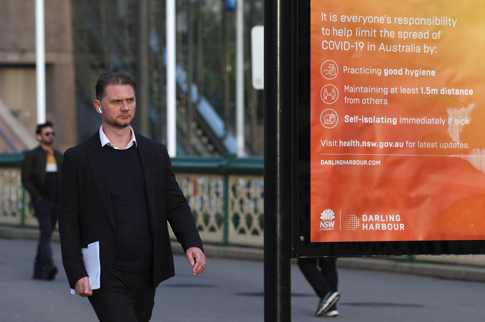 A man walks near an information board following the easing of restrictions implemented to curb the spread of the coronavirus, at Darling Harbour near the city center in Sydney, Australia, May 18, 2020. (Reuters Photo)