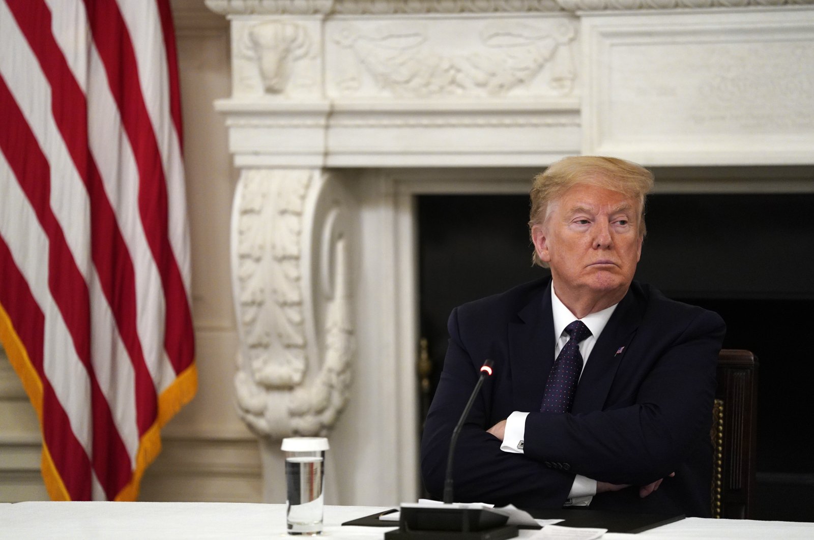 U.S. President Donald Trump listens during a meeting with restaurant industry executives about the coronavirus response, in the State Dining Room of the White House, Monday, May 18, 2020, in Washington. (AP Photo)