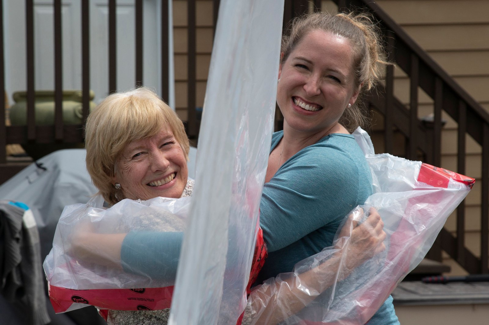 Carolyn Ellis (R) hugs her mother Susan Watts using the "Hug Glove" that they created as a Mother's Day gift in Guelph, Ontario, Canada, May 16, 2020. (AFP Photo)