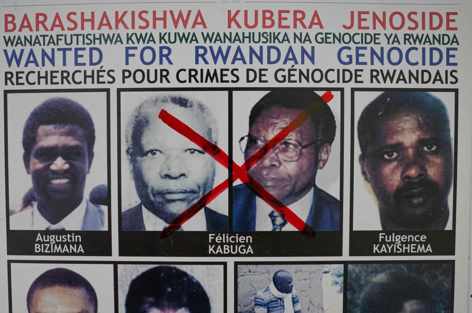 A red cross is seen drawn on the face of Felicien Kabuga, one of the last key suspects in the 1994 Rwandan genocide, on a wanted poster at the Genocide Fugitive Tracking Unit office in Kigali, Rwanda, May 19, 2020. (AFP)