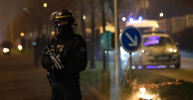 A French riot police officer secures the area during a protest in Bobigny, a district of northeast Paris, Feb. 11, 2017. (AFP Photo)