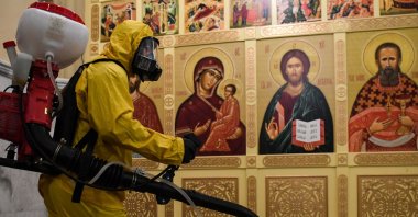A serviceman of Russia's Emergencies Ministry wearing protective gear disinfects Leningradsky railway station amid the coronavirus pandemic, Moscow, May 19, 2020. (AFP Photo)