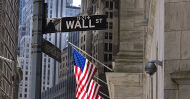 A view of a sign for Wall Street and the New York Stock Exchange in New York, New York, USA, 20 May 2020. The New York Exchange is set to reopen its trading floor next week after being closed since March due to the coronavirus pandemic. (EPA Photo)