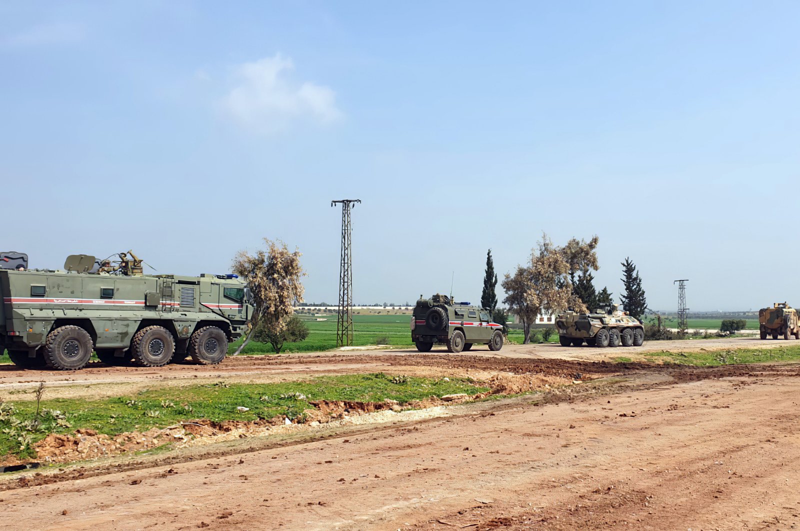In this photo provided by the Turkish Defense Ministry, Turkish and Russian troops patrol on the M4 highway, which runs east-west through Idlib province, Syria, Sunday, March 15, 2020 (Defense Ministry Photo)