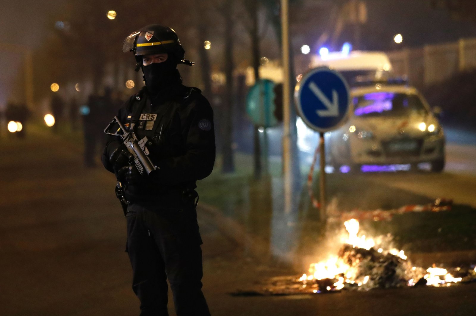 A French riot police officer secures the area during a protest in Bobigny, a district of northeast Paris, Feb. 11, 2017. (AFP Photo)