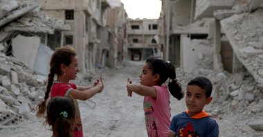 Syrian children are seen play amidst the rubble of damaged buildings in Deraa, July 15, 2017. (Reuters)