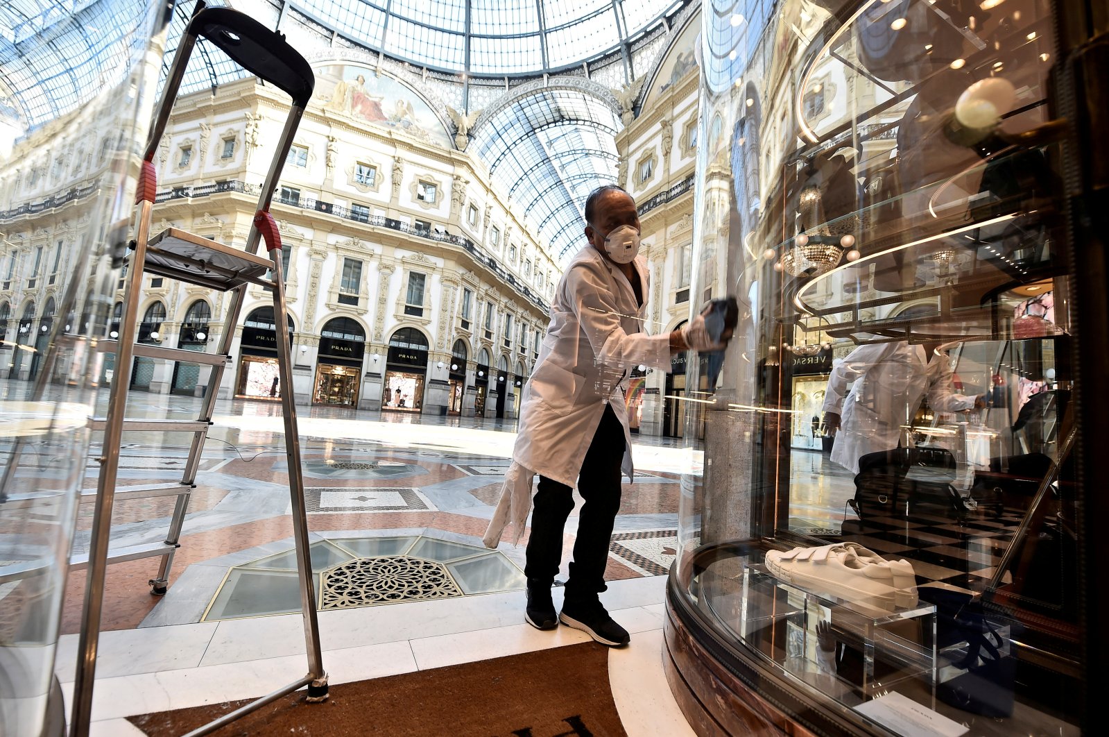 A worker prepares a store on the reopening day at Galleria Vittorio Emanuele II, as Italy eases some of the lockdown measures put in place during the coronavirus outbreak, in Milan, Italy, May 18, 2020. (Reuters Photo)
