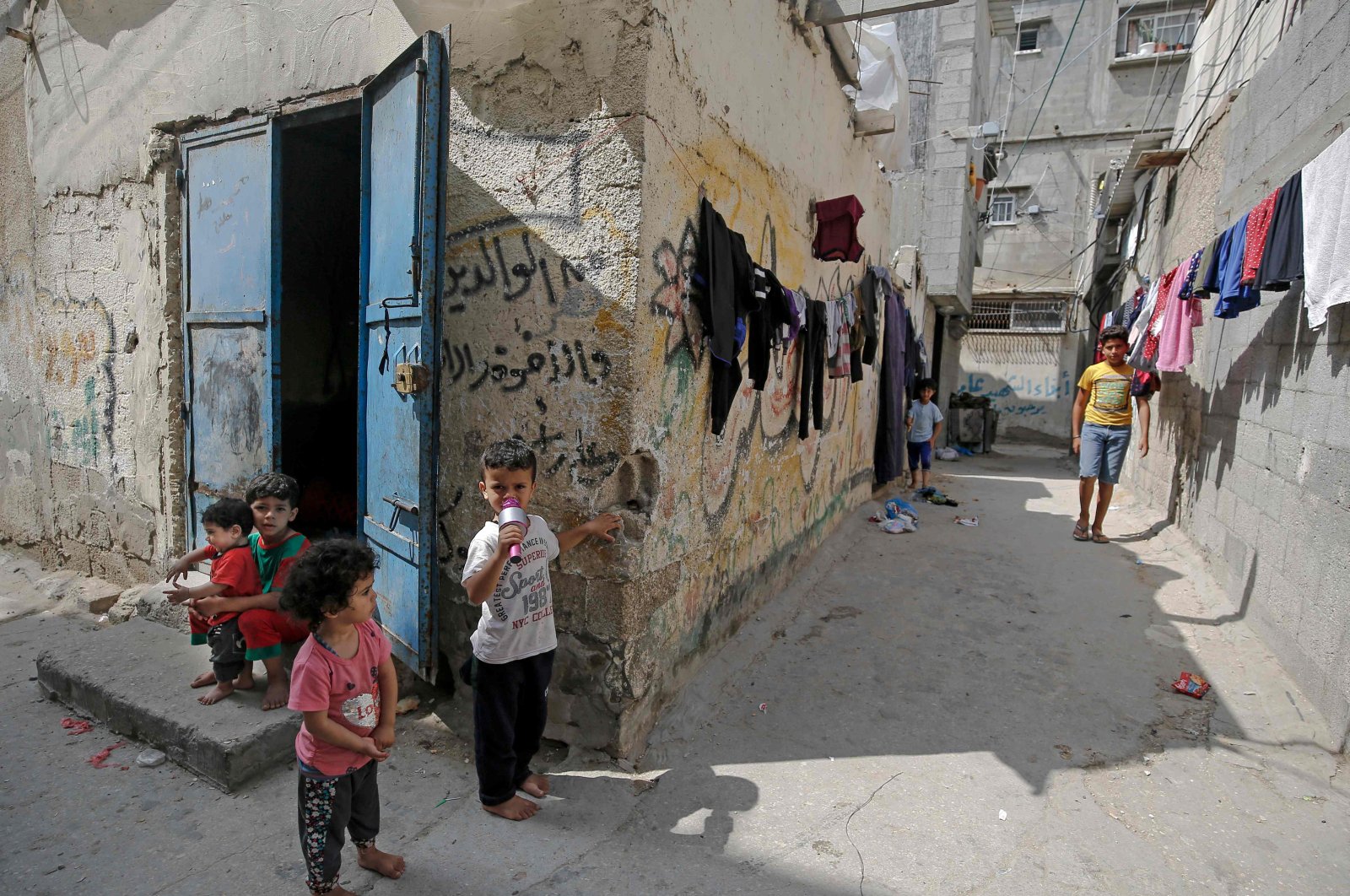 Palestinian children outside their shacks in Gaza City's al-Shati refugee camp, May 15, 2020. (AFP Photo)