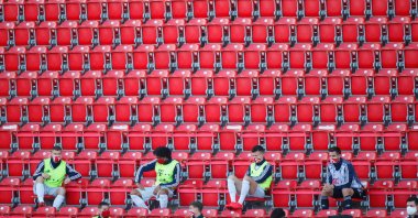 Bayern Munich substitutes wearing protective face masks maintain social distance in the stands during a Bundesliga football match against Union Berlin in Berlin, Germany, May 17, 2020. (AFP Photo)