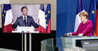 German Chancellor Angela Merkel listens during a joint press conference with French President Emmanuel Macron at the Chancellery, Berlin, May 18, 2020. (AFP Photo)