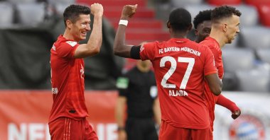 Bayern Munich's Polish forward Robert Lewandowski (L) celebrates scoring the third goal with Bayern Munich's Austrian defender David Alaba during their Bundesliga match against Eintracht Frankfurt, Munich, southern Germany, May 23, 2020.