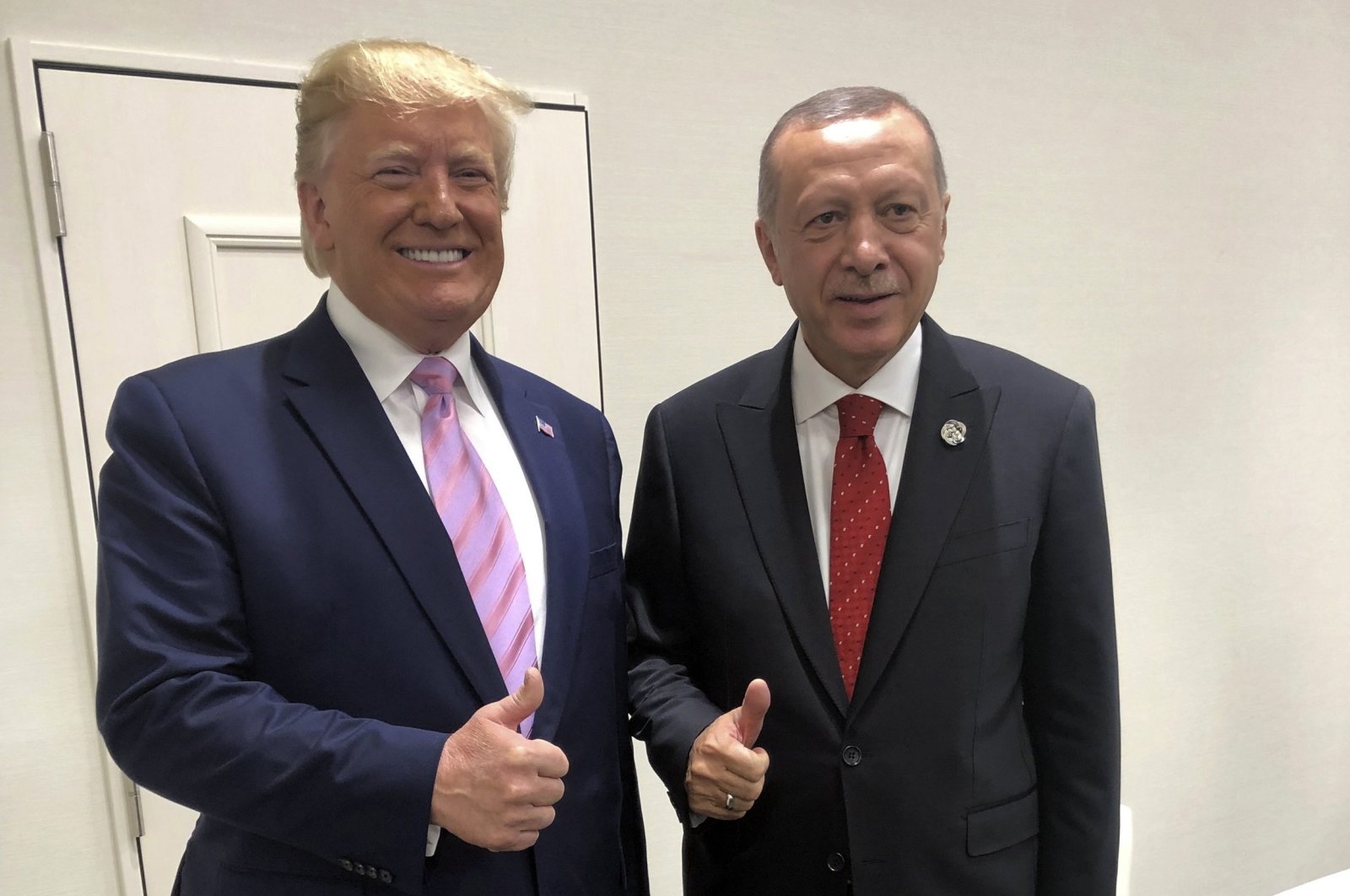 President Recep Tayyip Erdoğan, and U.S President Donald Trump gesture during the G-20 summit in Osaka, Japan, Friday, June 28, 2019. (AP Photo)