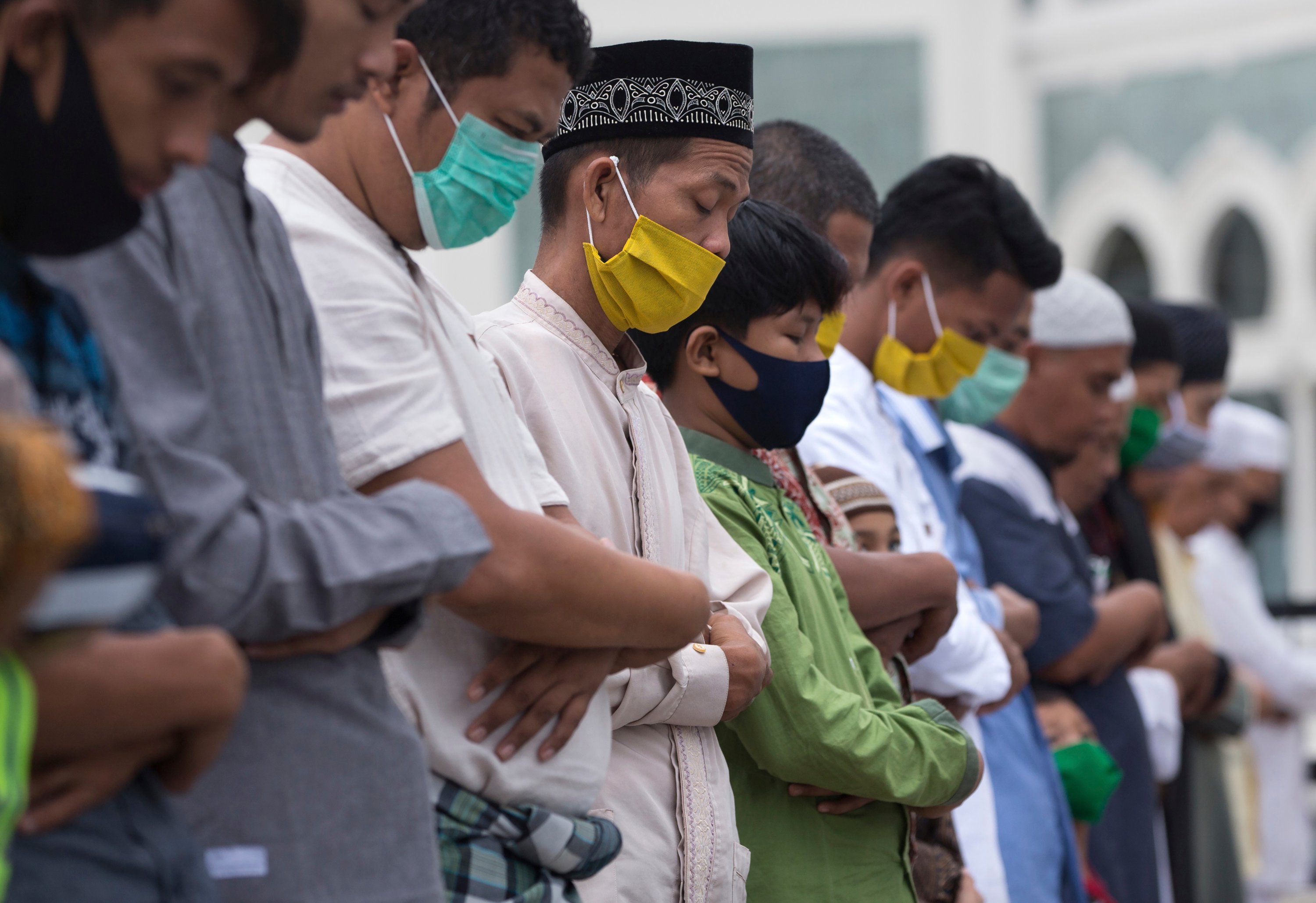 Muslims wearing face masks offer the Eid al-Fitr prayer at Al Mashun Grand Mosque, Medan, North Sumatra, Indonesia, May 24, 2020. (AP Photo)