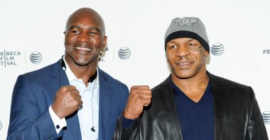 Evander Holyfield (L) and Mike Tyson pose together at an event in New York, U.S., April 19, 2014. (AP Photo)