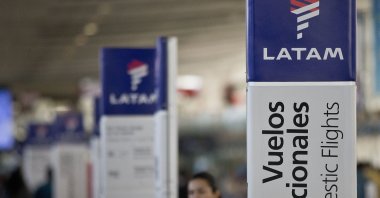 An agent of LATAM airlines stands by the counters at the airport in Santiago, Chile, July 25, 2016. (AP Photo)