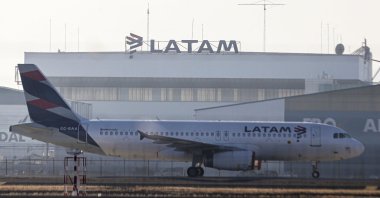 A Latam airplane sits parked at the Arturo Merino Benitez airport in Santiago, Chile, Tuesday, May 26, 2020. (AP Photo)