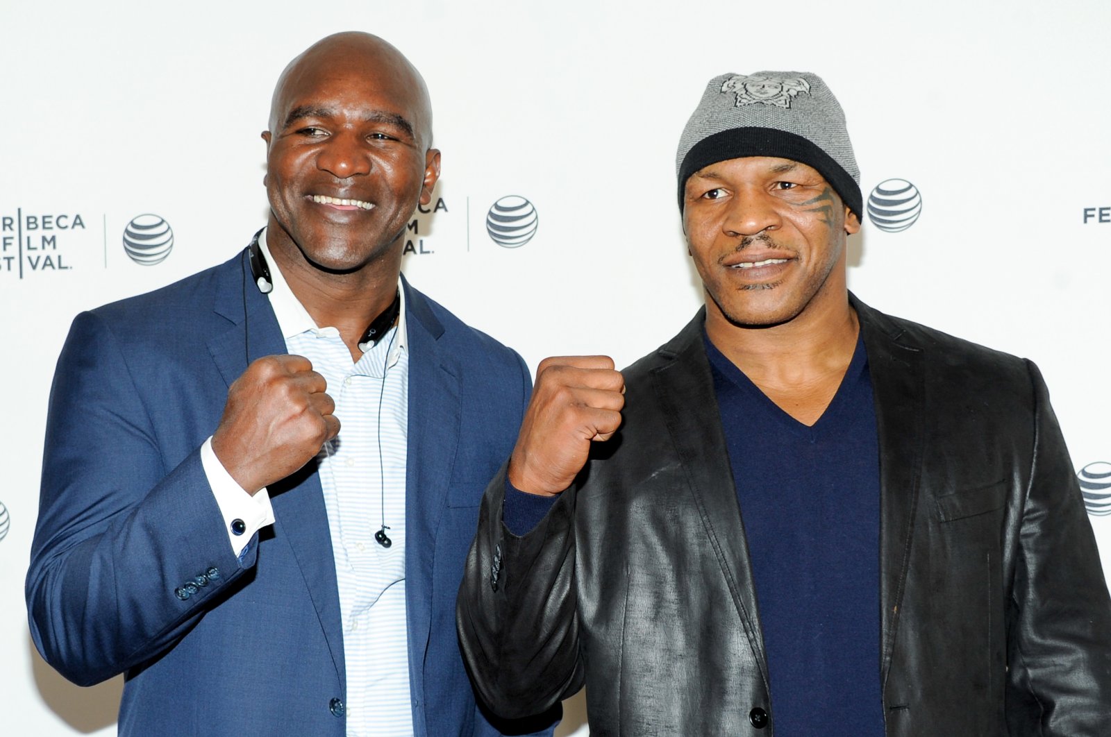 Evander Holyfield (L) and Mike Tyson pose together at an event in New York, U.S., April 19, 2014. (AP Photo)