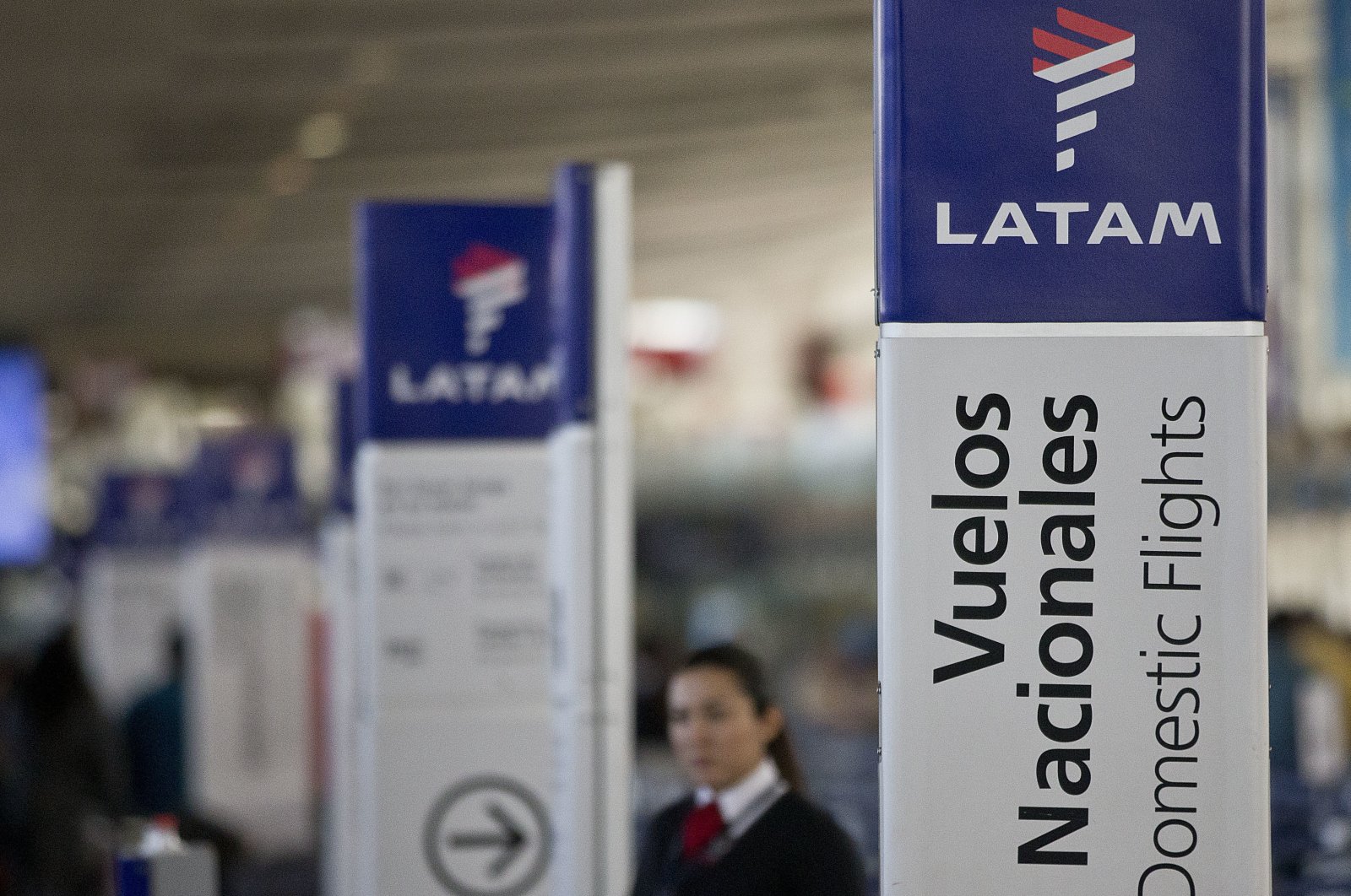 An agent of LATAM airlines stands by the counters at the airport in Santiago, Chile, July 25, 2016. (AP Photo)