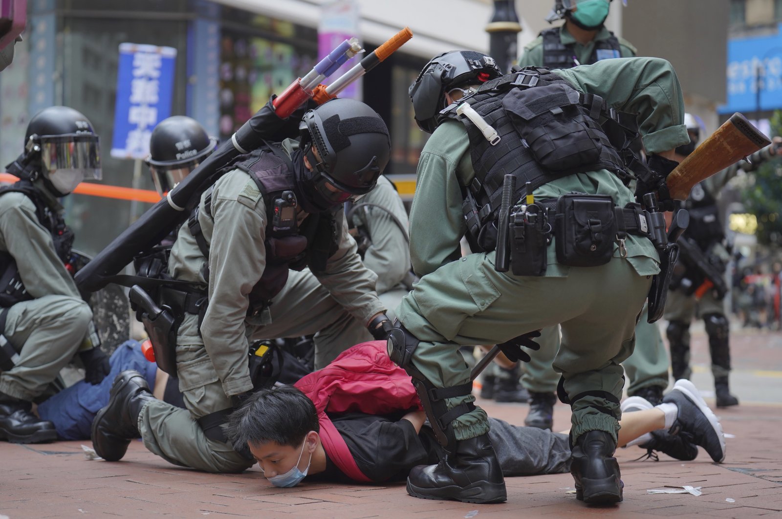 Riot police detain a protester during a demonstration against Beijing's national security legislation in Causeway Bay in Hong Kong, Sunday, May 24, 2020. (AP Photo)
