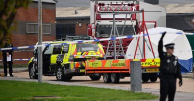 British Police officers work by a lorry, believed to have originated from Bulgaria, and containing 39 dead bodies, discovered at Waterglade Industrial Park in Grays, east of London, Oct. 23, 2019. (AFP Photo)