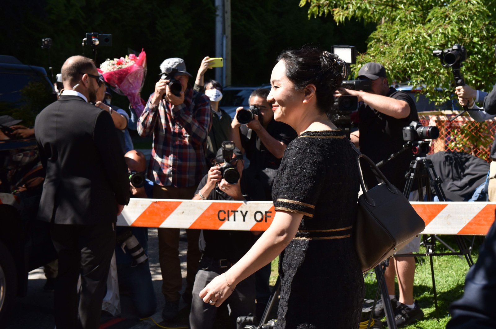Chinese Huawei tech executive Meng Wanzhou leaves her Vancouver home to appear in British Columbia Supreme Court, May 27,2020. (AFP)