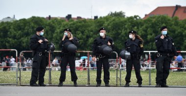 Police officers stand guard in front of a demonstration, Munich, Germany, May 23, 2020. (AFP Photo)