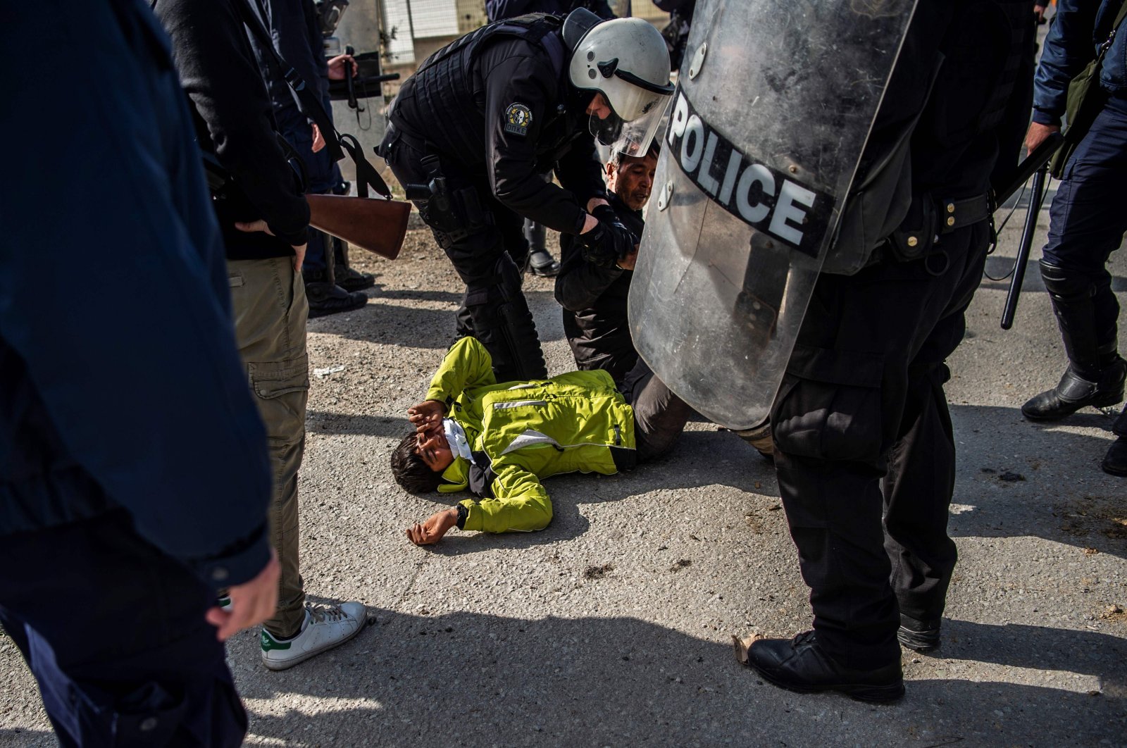 Greek riot police detain a migrant teen during clashes near the Moria camp for refugees and migrants, on the island of Lesbos, Greece, March 2, 2020. (AFP Photo)
