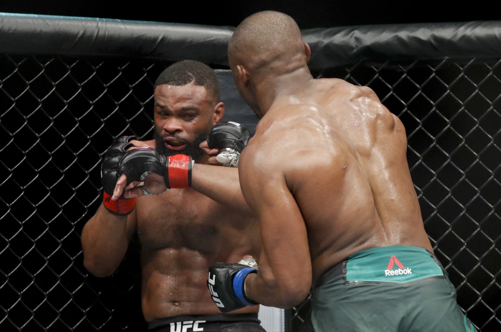 Kamaru Usman (R) hits Tyron Woodley in a welterweight mixed martial arts title fight at UFC 235, Las Vegas, U.S., March 2, 2019. (AP Photo)